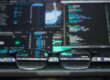 close up photo of eyeglasses in front of a monitor
